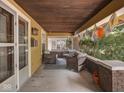 Inviting covered front porch with comfortable seating and brick pillars, perfect for relaxation at 4220 Sunset Ave, Indianapolis, IN 46208