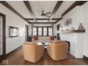 Bright living room features hardwood floors, exposed beam ceiling, fireplace, and classic architecture at 4220 Sunset Ave, Indianapolis, IN 46208