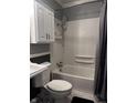Bathroom with white subway tile surround, shower head, white cabinets and gray beadboard at 4916 Ingleside Ln, Indianapolis, IN 46227