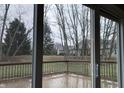 View from sliding glass doors to wooden back deck and large backyard at 5746 Overcrest Dr, Indianapolis, IN 46237