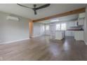 Bright, open floor plan showcasing hardwood floors, wooden beam, and a view to the kitchen at 7302 N Banta Rd, Bargersville, IN 46106