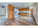 Open kitchen with stainless steel appliances and wood cabinets at 770 Berkley Dr, Fortville, IN 46040
