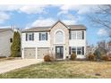 Beautiful two-story home with attached garage, brick and vinyl siding and well-manicured lawn at 10400 Hillsborough Dr, Fishers, IN 46037