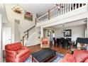 Open living room featuring hardwood floors, staircase, and adjacent dining area at 10400 Hillsborough Dr, Fishers, IN 46037