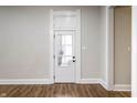 Bedroom door showcasing white trim and neutral walls, with hardwood floors at 1133 Olive St, Indianapolis, IN 46203