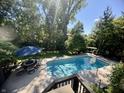 Beautiful backyard pool with ample seating area, perfect for outdoor entertaining and enjoying the sunshine at 13265 Talon Crest Dr, Fishers, IN 46037