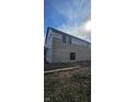 View of a house under construction with light brown siding and black windows in place at 1523 N Beville Ave, Indianapolis, IN 46201