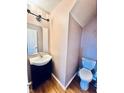 Cozy half bathroom with a single sink vanity and blue toilet at 1708 Sonesta Way, Indianapolis, IN 46217