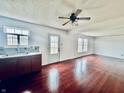 Open living space with hardwood floors, a ceiling fan, and bright natural light at 1708 Sonesta Way, Indianapolis, IN 46217