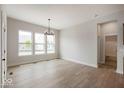 Spacious dining area featuring bright natural light, elegant chandelier and hardwood style floors at 19826 Chatham Shore Ln, Westfield, IN 46074