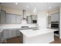 Modern kitchen with white countertops, gray cabinets, stainless steel appliances, and pendant lighting at 19995 Meadow Neck Rd, Westfield, IN 46074