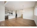 Open floorplan featuring hardwood floors, a gray kitchen, modern lighting, and large windows at 19995 Meadow Neck Rd, Westfield, IN 46074