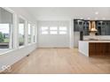 Spacious living room featuring new floors and large windows providing plenty of natural light next to kitchen at 20017 Old Dock Rd, Westfield, IN 46074