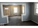 Open living room with a view of the front door and multiple windows at 2029 Laurel St, Indianapolis, IN 46203