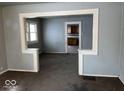 Living room with a view of the open archway to the kitchen at 2029 Laurel St, Indianapolis, IN 46203