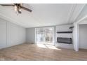 Bright living room with a brick fireplace, sleek flooring, and sliding glass doors to the outdoor deck at 2209 Thornewood Dr, Anderson, IN 46012