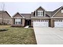 Charming single-Gathering home boasting a brick facade, complemented by a two-car garage and well-maintained lawn at 253 Darrough Dr, Greenwood, IN 46143