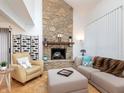 Spacious living room featuring a stone fireplace, hardwood floors, and comfortable seating at 2563 Hideaway S Dr, Indianapolis, IN 46268