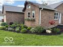 Brick home with flower boxes under windows and landscaped garden bed at 2650 W State Road 252, Flat Rock, IN 47234