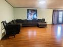 Spacious living room featuring sleek hardwood floors and a comfortable L-shaped couch for relaxation at 3330 Corey Dr, Indianapolis, IN 46227