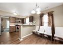 Open kitchen with brown cabinets, stainless appliances, and a bar-style counter with seating at 411 Red Tail Ln, Indianapolis, IN 46241