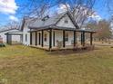 Charming exterior elevation of home featuring a metal roof and a cozy covered porch with seating at 4131 N County Road 500 E, Danville, IN 46122