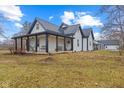 Charming exterior elevation of home featuring a metal roof and a cozy covered porch with seating at 4131 N County Road 500 E, Danville, IN 46122