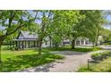 Charming home featuring a white exterior, metal roof, and well-maintained landscaping at 4131 N County Road 500 E, Danville, IN 46122