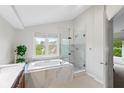 Luxurious bathroom featuring a soaking tub and a glass-enclosed shower at 5208 Clear Lake Ct, Carmel, IN 46033