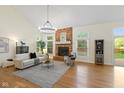 Bright living room with vaulted ceilings, a brick fireplace, and hardwood floors at 5208 Clear Lake Ct, Carmel, IN 46033