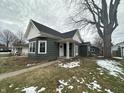 Charming home with green siding, white trim, decorative porch, and a well-kept lawn at 806 S 17Th St, Elwood, IN 46036