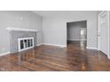 Open living room with fireplace, light gray walls and hardwood flooring at 806 S 17Th St, Elwood, IN 46036