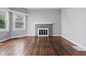 Cozy living room boasts hardwood floors, a brick fireplace, and plenty of natural light at 806 S 17Th St, Elwood, IN 46036