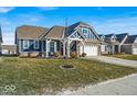 Charming two-story home with blue siding, a brick foundation and a well-manicured lawn at 980 Cortland Ct, Westfield, IN 46074