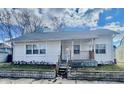 Charming home exterior with an inviting front porch and well-maintained yard at 117 W 36Th St, Indianapolis, IN 46208