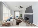 Bright living room with neutral tones, a ceiling fan, and a cozy fireplace at 117 W 36Th St, Indianapolis, IN 46208