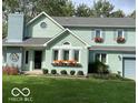 Charming two-story home with well-maintained lawn, flower boxes, and attached two car garage at 11710 E 75Th St, Indianapolis, IN 46236