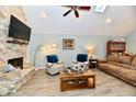 Spacious living room with stone fireplace, ceiling fan and comfortable seating area at 11710 E 75Th St, Indianapolis, IN 46236