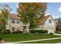 Charming two-story home with brick accents, lush lawn, balcony, and mature tree at 12576 Mojave Dr, Fishers, IN 46037