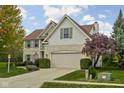 Charming two-story home with brick accents, lush lawn, green shutters, and attached two car garage at 12576 Mojave Dr, Fishers, IN 46037
