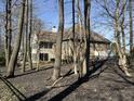 View of a home exterior with a wooded backyard with mature trees, an iron fence, and a partial view of the house at 13221 Barnegat Ln, Fishers, IN 46055