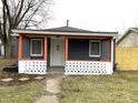 Charming home with front porch featuring white door, fresh paint, and well-manicured yard at 3314 S Parker Ave, Indianapolis, IN 46237