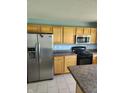 Functional kitchen with stainless steel refrigerator and modern appliances, and ample counter space at 3416 Firethorn Dr, Whitestown, IN 46075
