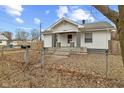 Charming home featuring a well-maintained lawn, fenced yard, and inviting front porch at 3950 W Michigan St, Indianapolis, IN 46222