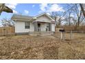 Charming home featuring a well-maintained lawn, fenced yard, and inviting front porch at 3950 W Michigan St, Indianapolis, IN 46222