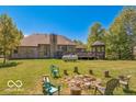 Large backyard with mature trees, fire pit area, and raised deck with gazebo and brick chimney at 4030 W 193Rd St, Westfield, IN 46074