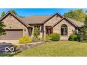 Charming brick home featuring manicured lawn, tasteful landscaping, and an attached two-car garage at 4030 W 193Rd St, Westfield, IN 46074