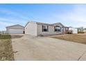 A home's side view shows a detached garage with a long driveway at 4676 Autumn Ridge Dr, Columbus, IN 47203