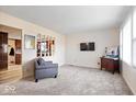 Inviting living room with neutral carpet, fresh paint, and large windows providing ample natural light at 5053 Manker St, Indianapolis, IN 46227