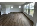 Spacious living room featuring hardwood floors, neutral walls, and plenty of natural light at 567 Hidden Hills Dr, Pittsboro, IN 46167